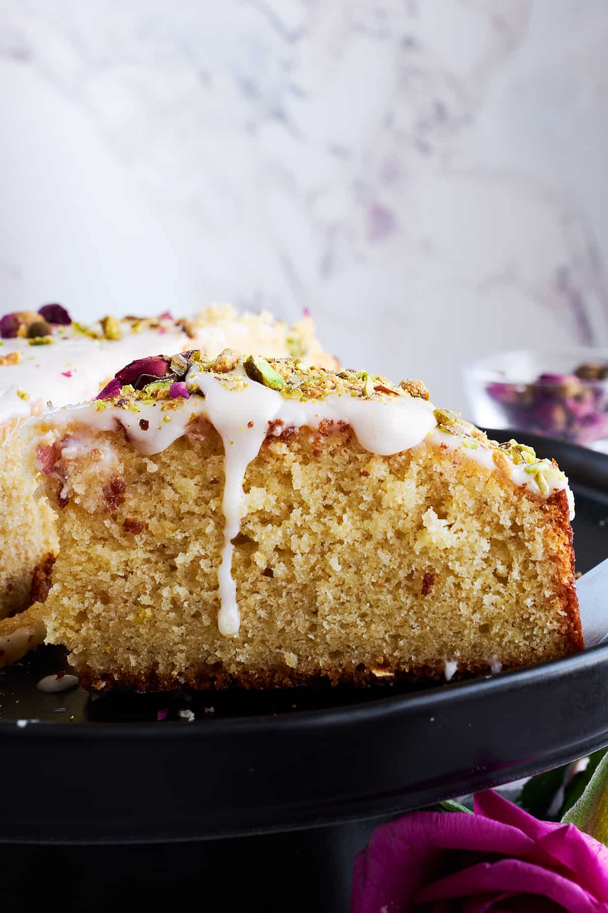 Side view of an iced Persian love cake slice. 