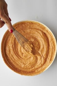 Chicken tikka sauce being whisked in a bowl.