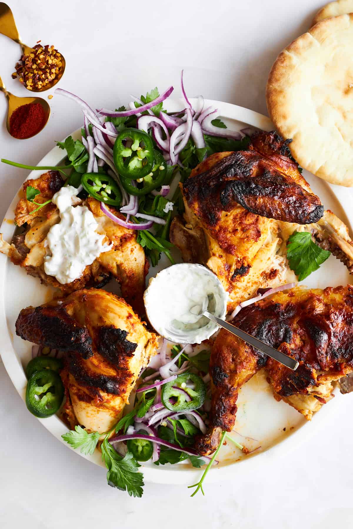 Chicken tikka on a plate with garnishes. 