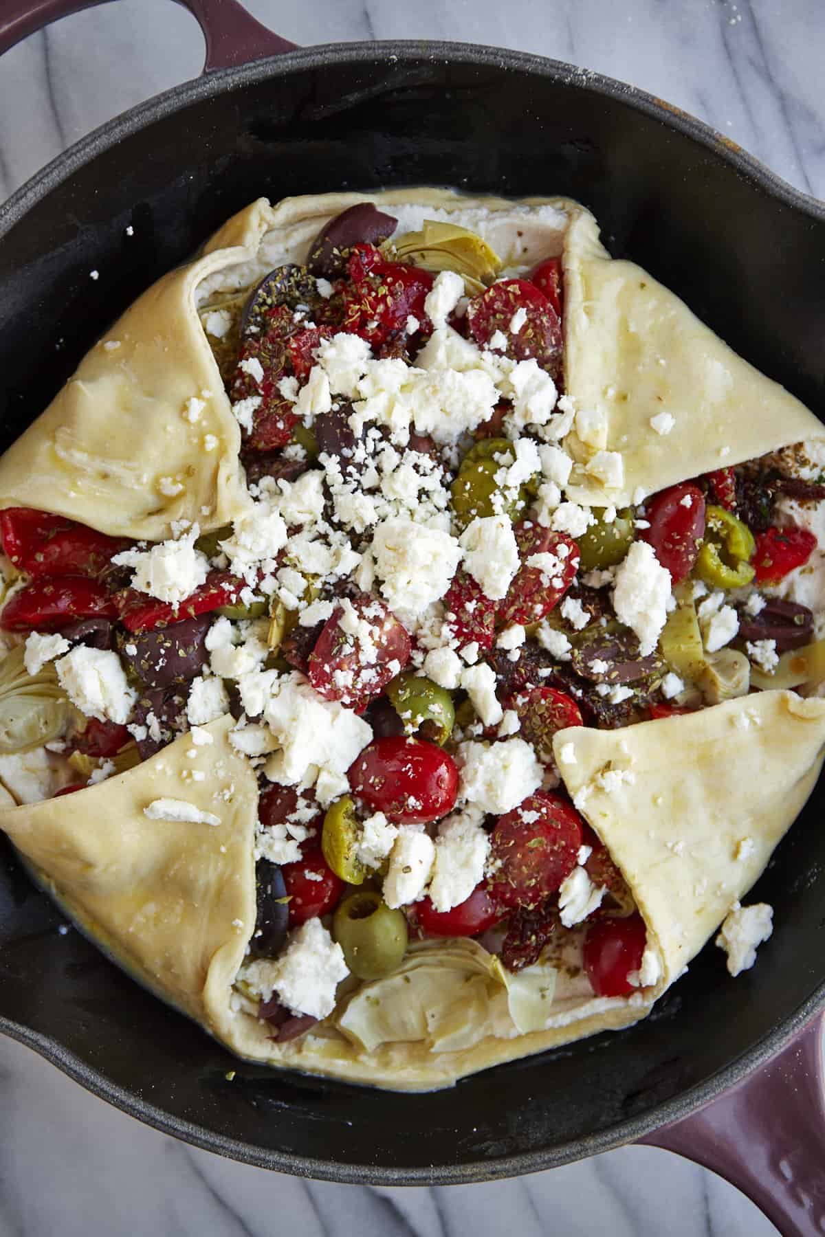 An unbaked Mediterranean vegetable galette. 