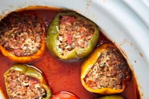 Cooked Mediterranean stuffed peppers in a slow cooker.
