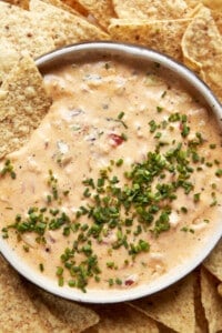 A bowl of baked chicken queso dip.