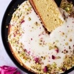Persian love cake with a piece on its side.