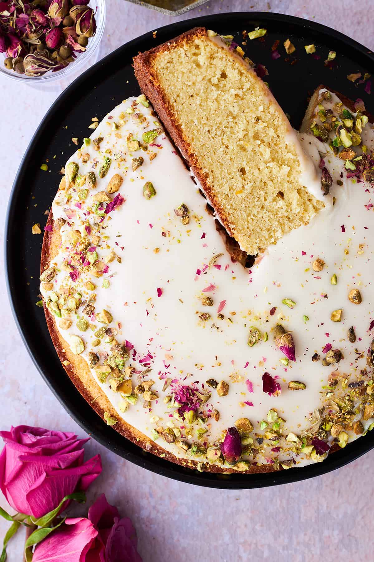 Persian love cake with a piece on its side.