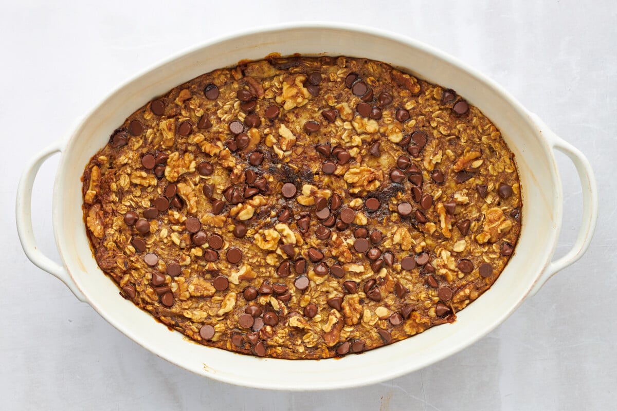 Banana date baked oatmeal in an oval baking dish.