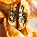 Spinach and cheese fatayer with one split in half.