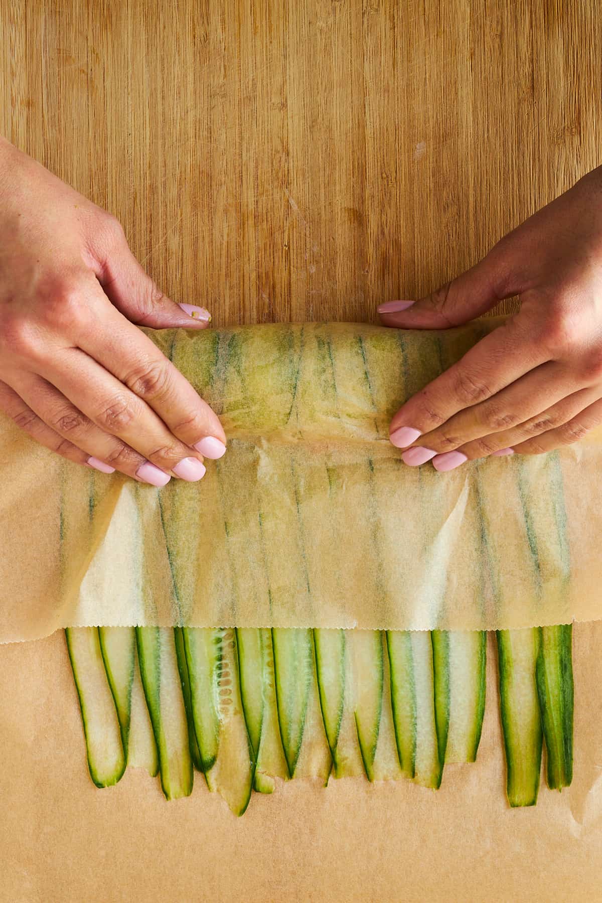 A cucumber roll being rolled. 