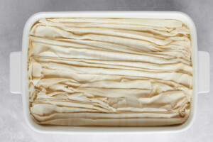Crinkled sheets of phyllo dough in a baking sheet.
