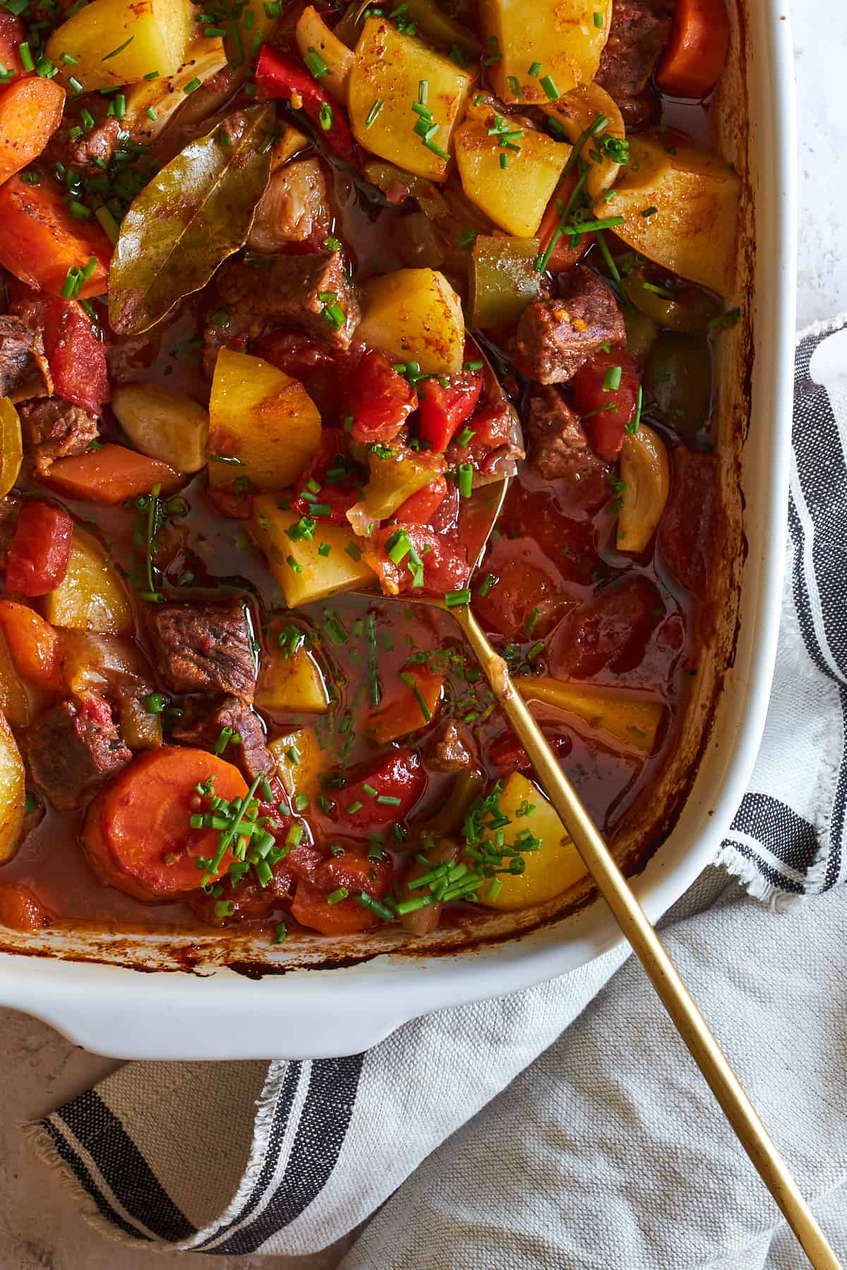 A casserole dish of baked beef stew. 