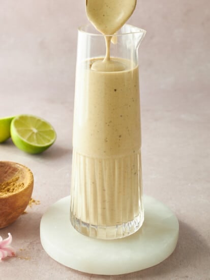 A glass jar of tahini dressing.