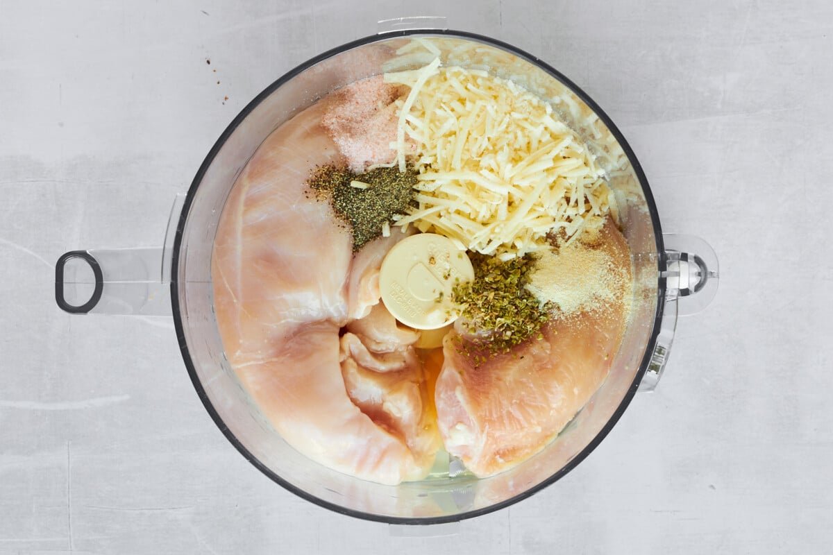 Chicken pizza crust ingredients in a food processor.