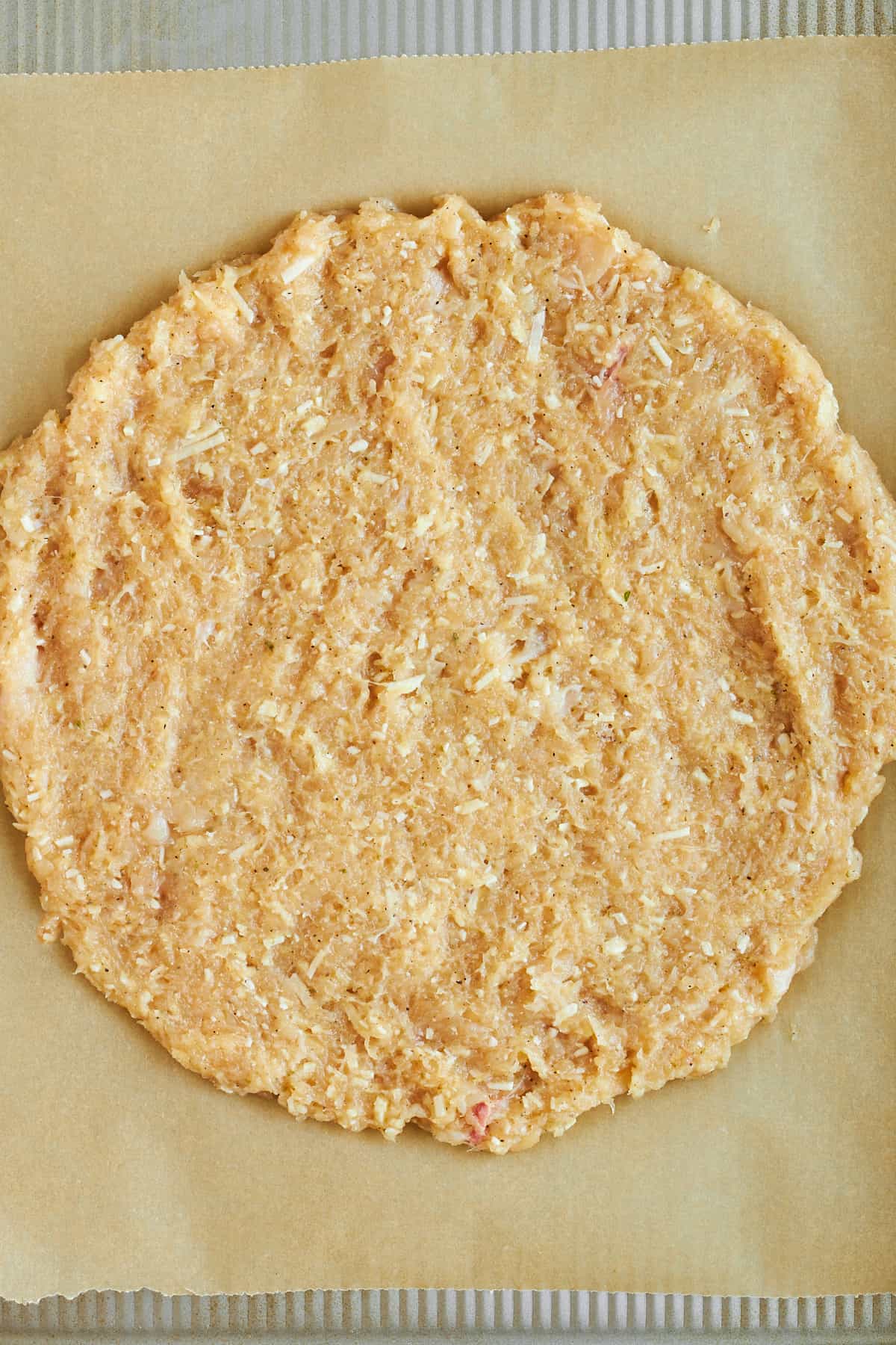 Raw chicken crust on a baking sheet. 