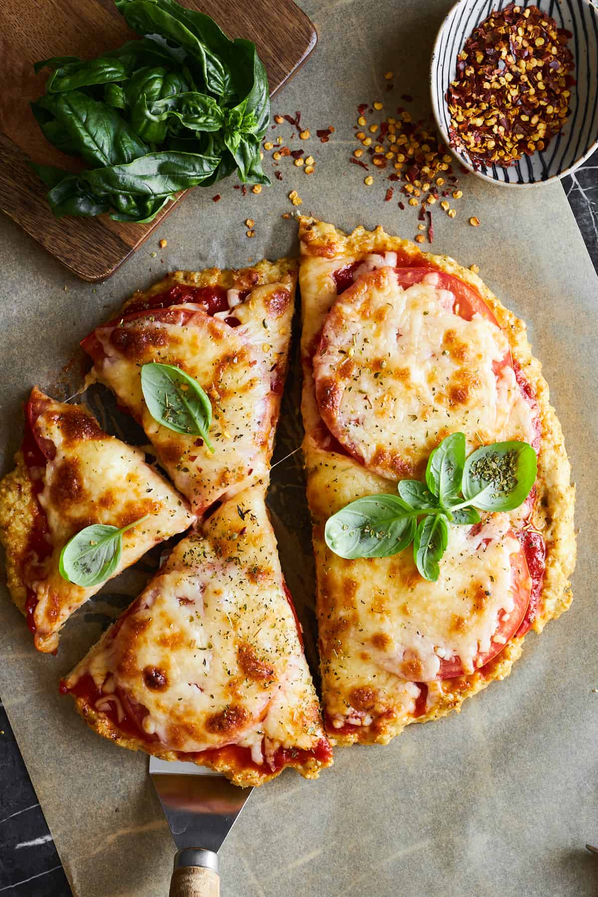 Chicken crust pizza with three pieces sliced. 