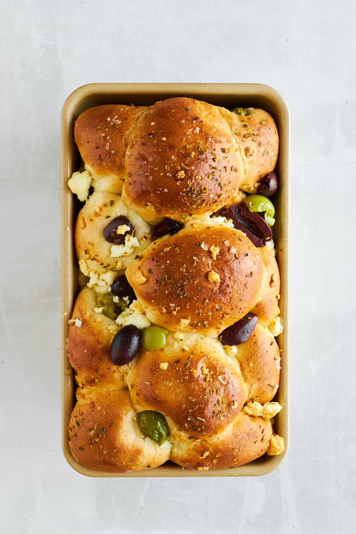 A love of feta olive bread in a bread pan. 