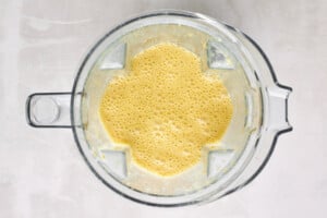Wet ingredients for orange cake in a blender.
