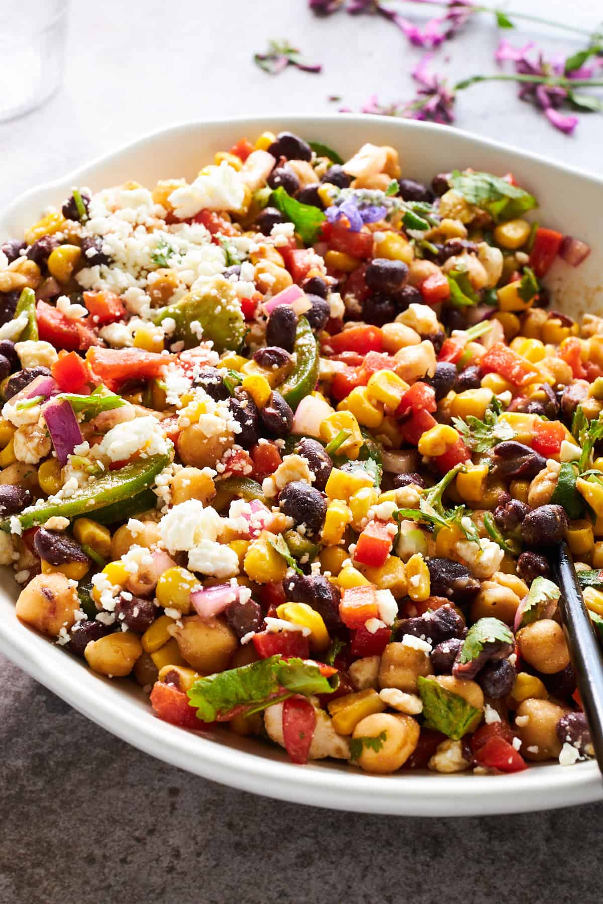 A bowl of black bean and corn salad topped with feta.