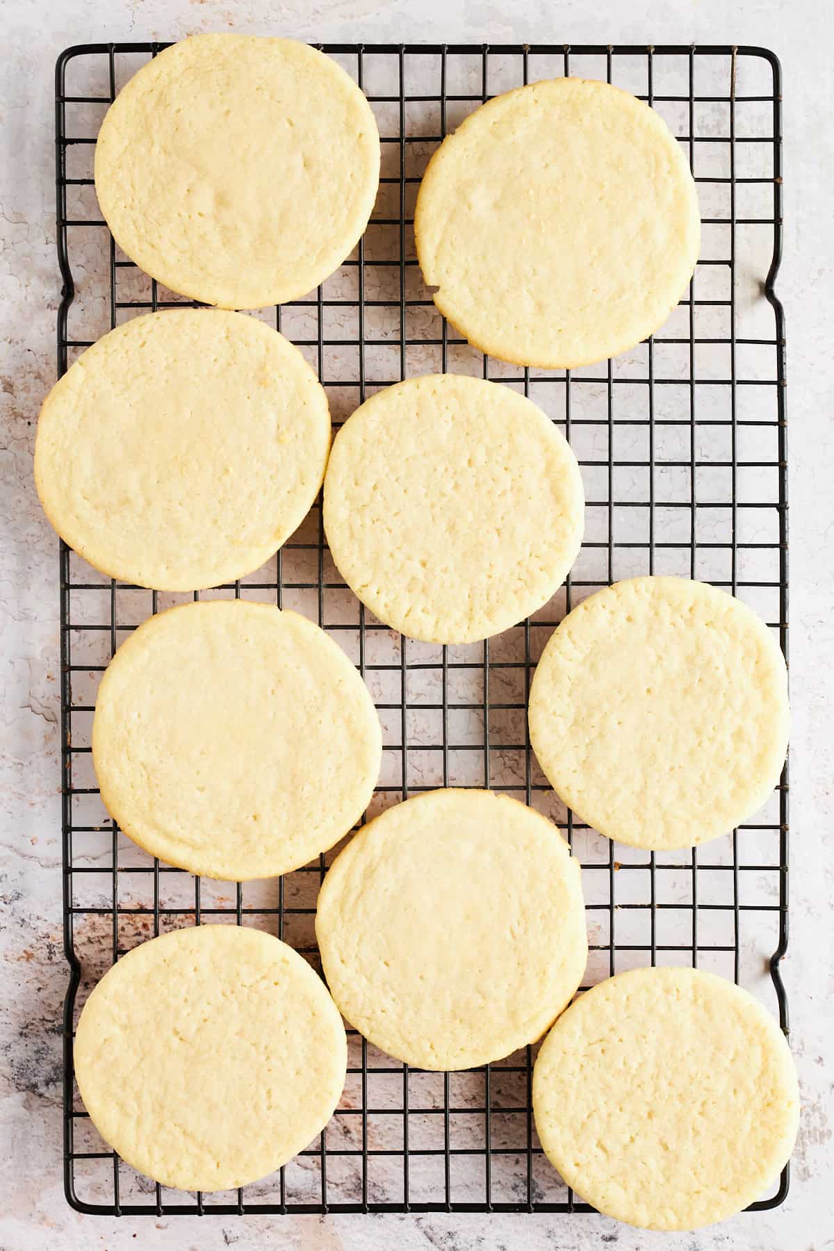 Sugar cookies on a wire rack.