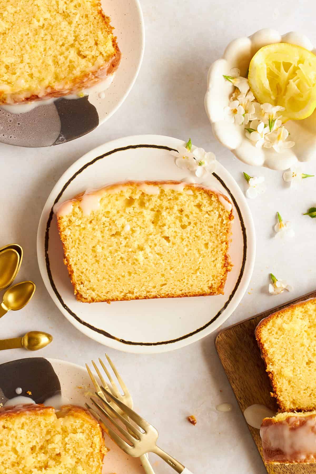 A slice of glazed lemon bread on a plate.