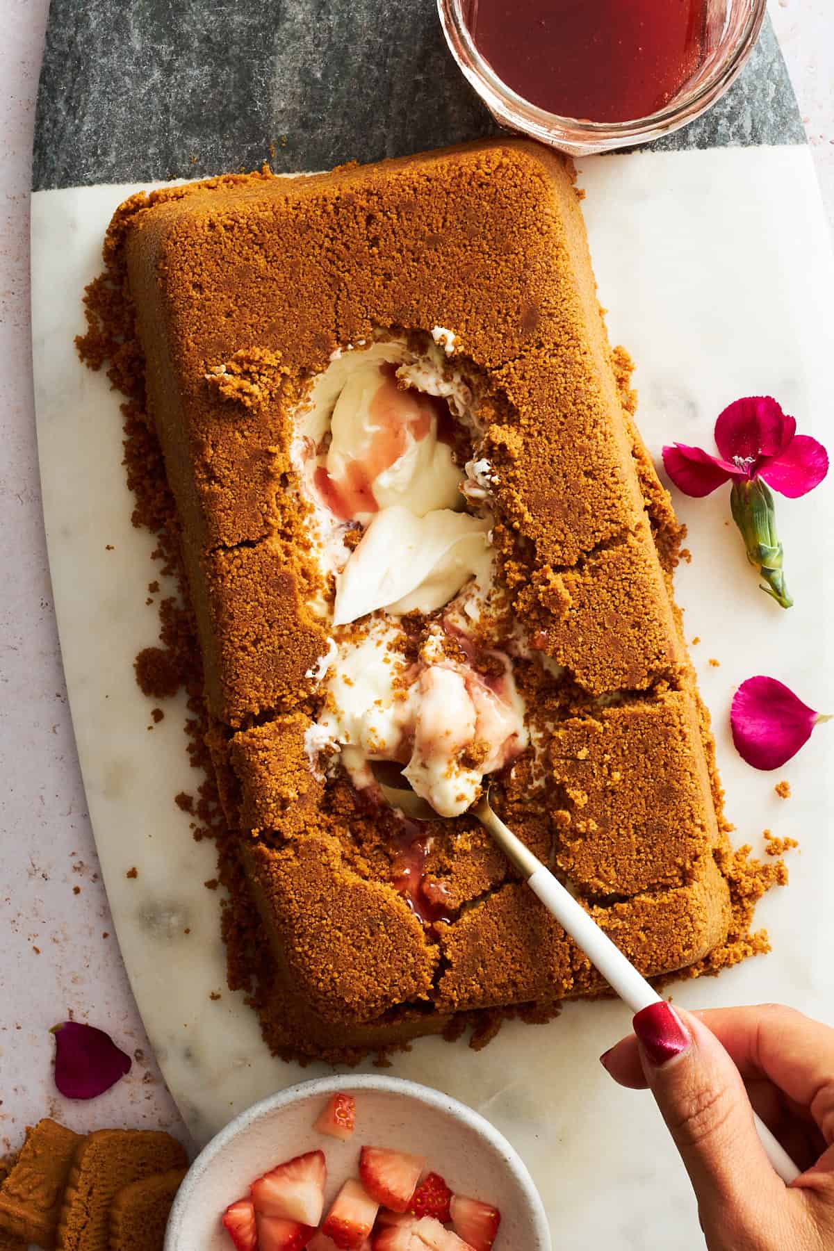 A spoon digging into the creamy center of an upside down cheesecake.