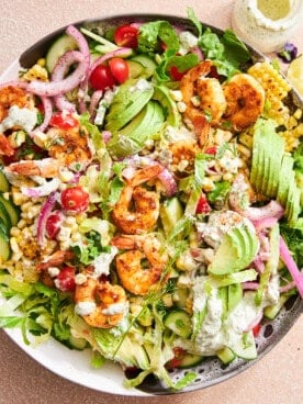 A bowl of shrimp avocado salad with creamy tahini.