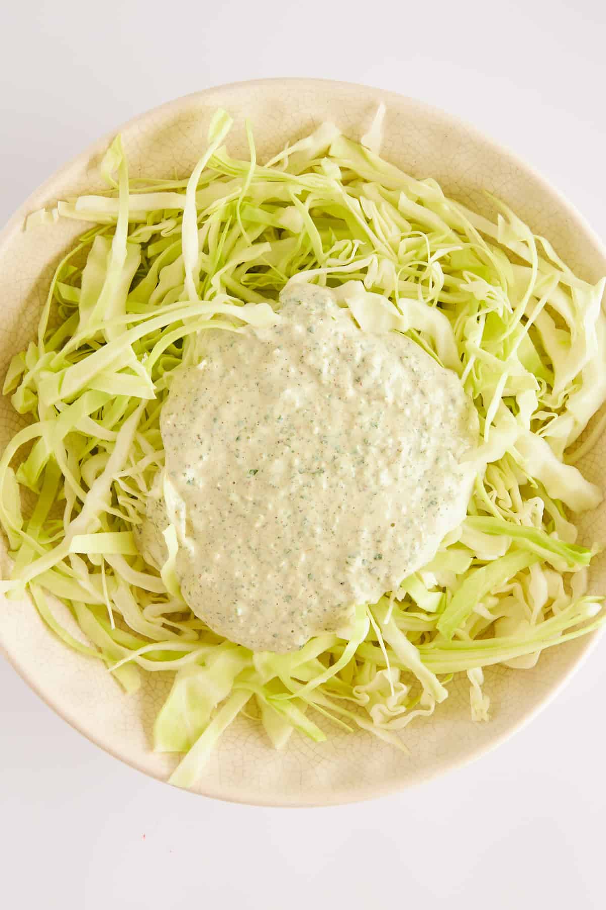 Shredded cabbage topped with dressing.
