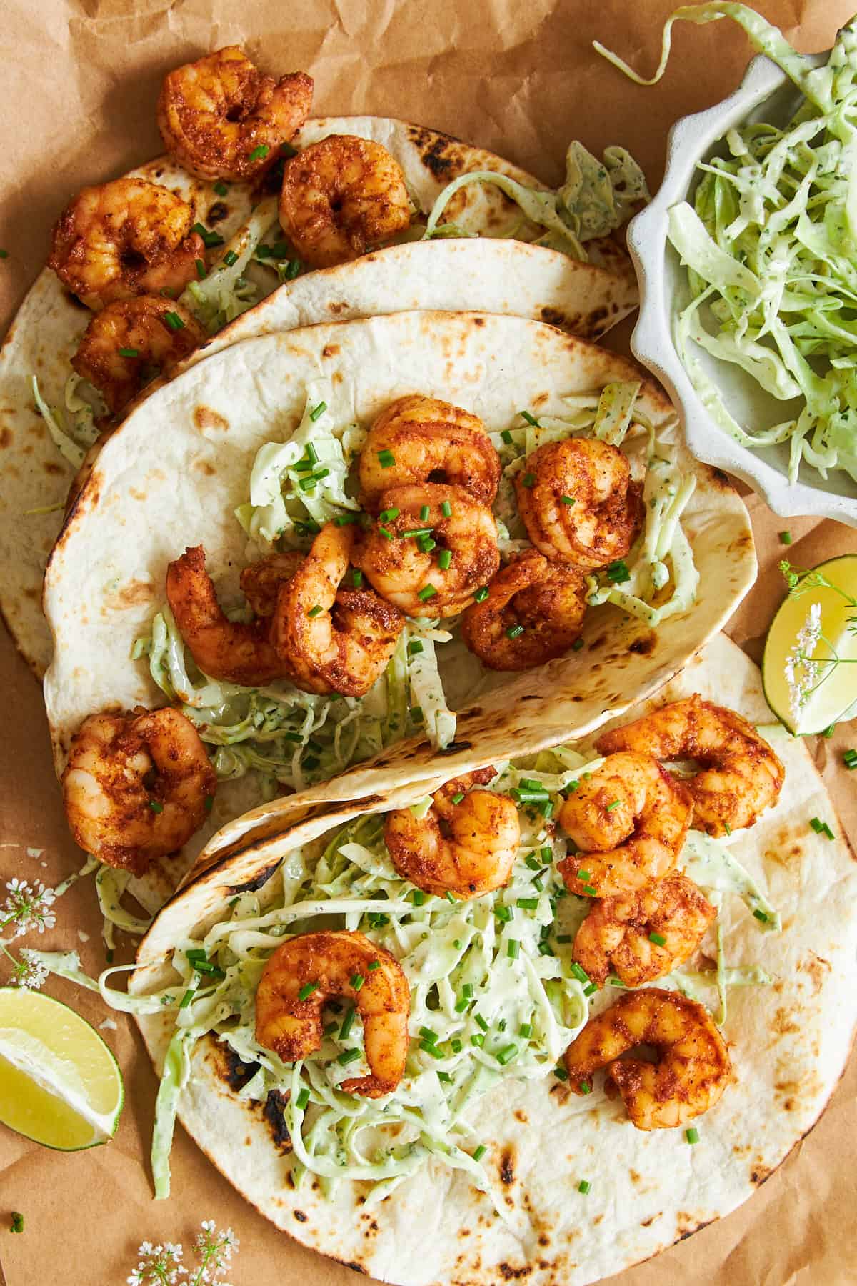 Three blackened shrimp tacos with slaw.