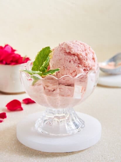 A serving cup of strawberry fruit ice cream.