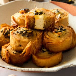 A plate of hot honey phyllo rolls.