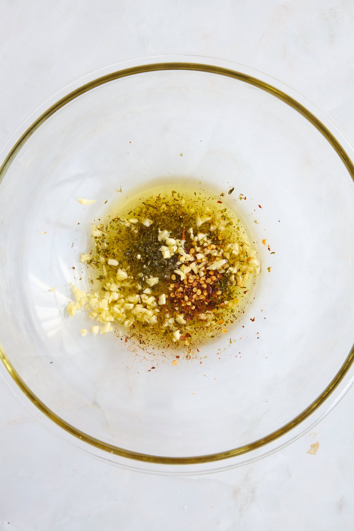 Olive oil and spices in a bowl.