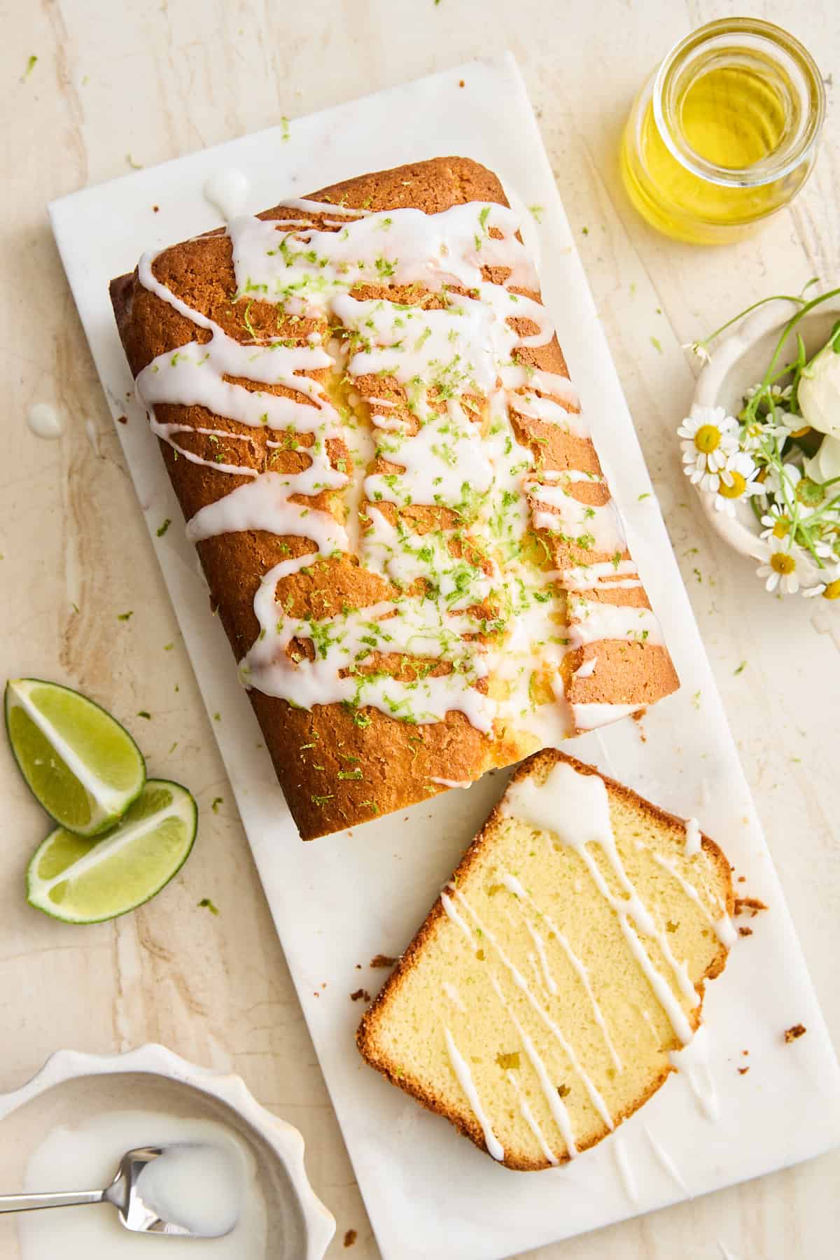 Key lime loaf on a cutting board with a slice cut.