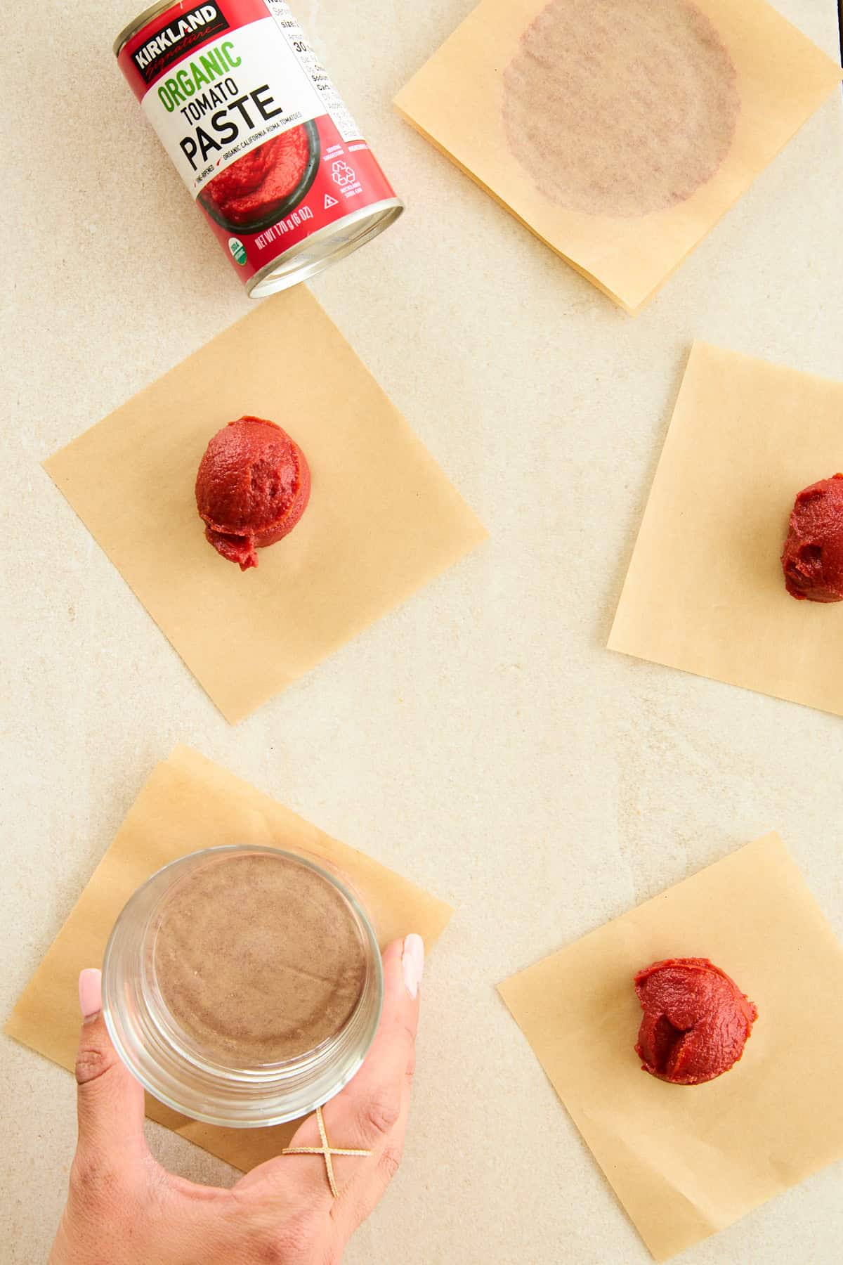 Tomato paste discs on sheets of parchment paper.