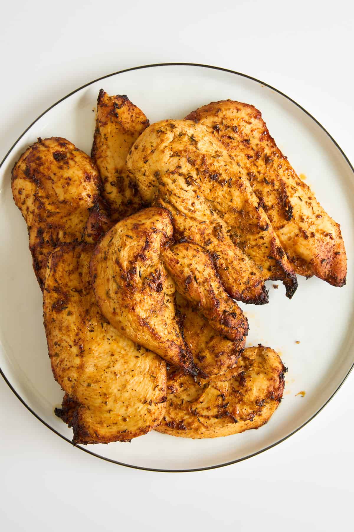 A plate of baked chicken breasts. 