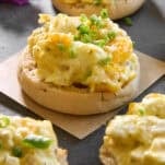 English muffin halves topped with baked scrambled eggs.