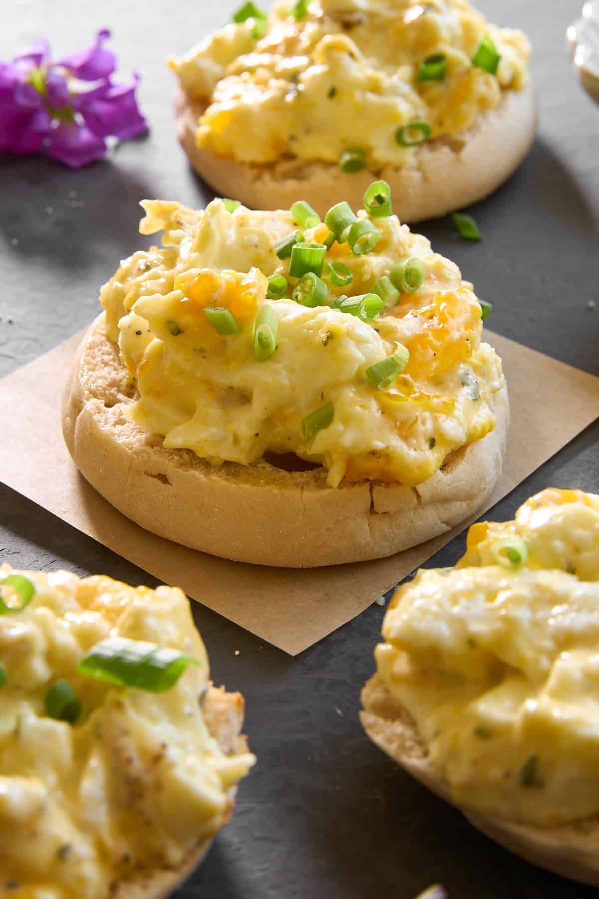 English muffin halves topped with baked scrambled eggs.