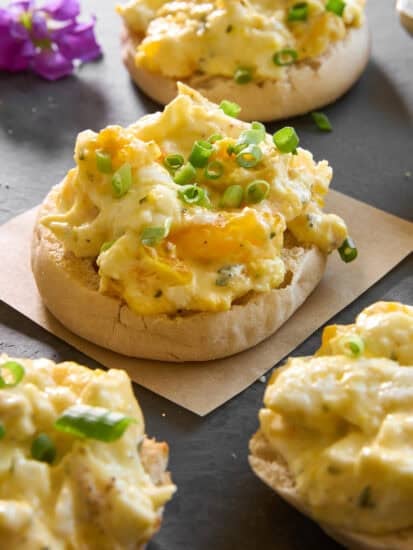 English muffin halves topped with baked scrambled eggs.