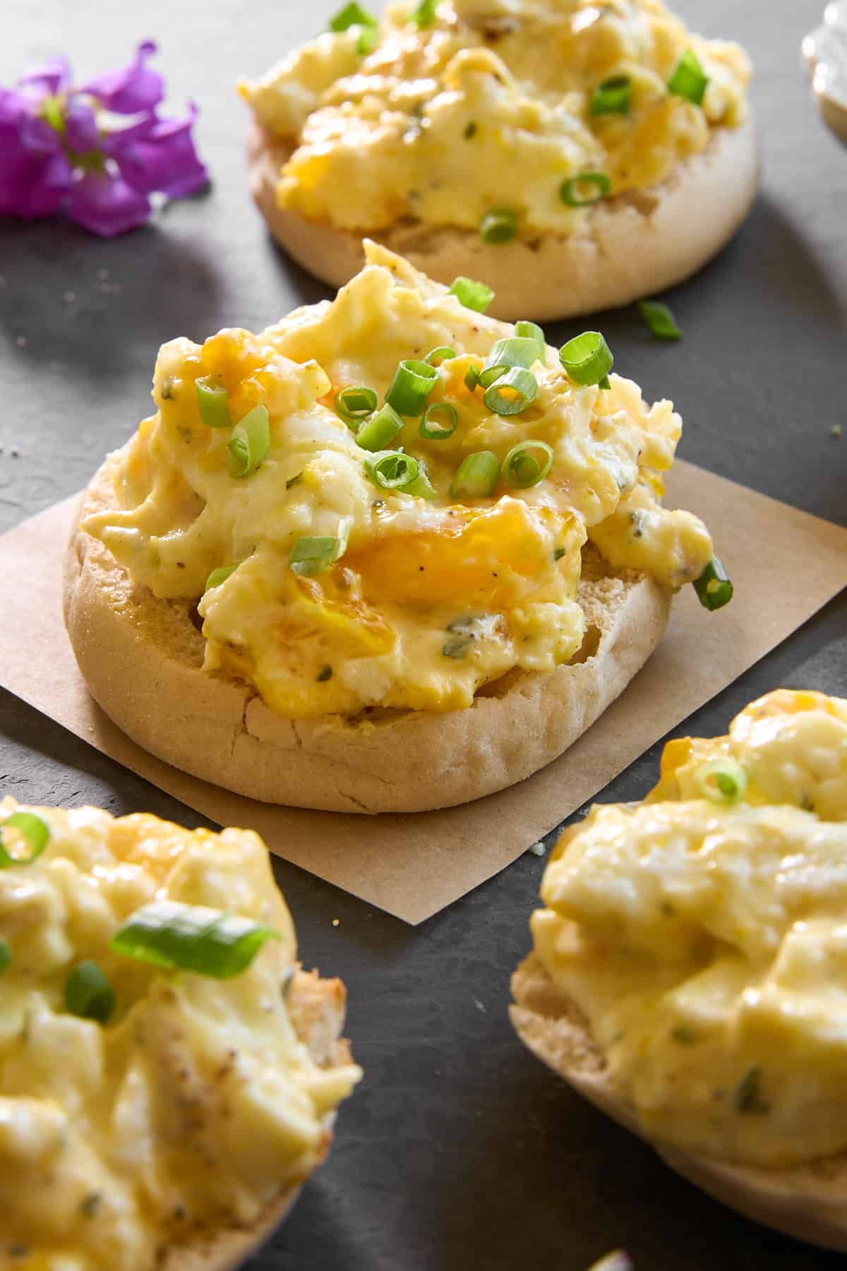 English muffin halves topped with baked scrambled eggs.