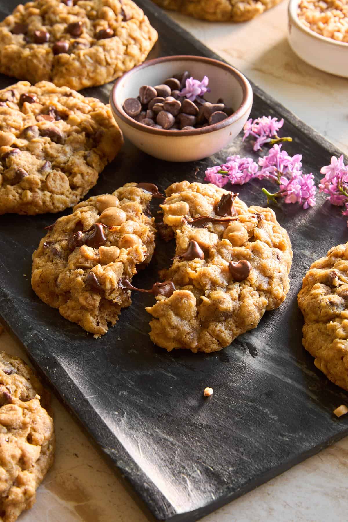 A platter of copycat Crumbl mom's cookies with one split in half.