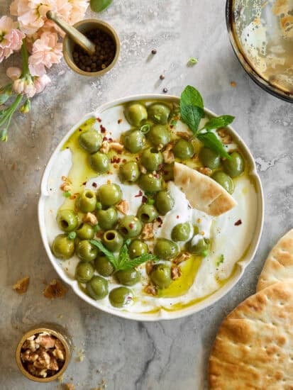 A bowl of whipped cottage cheese marinated olive dip.