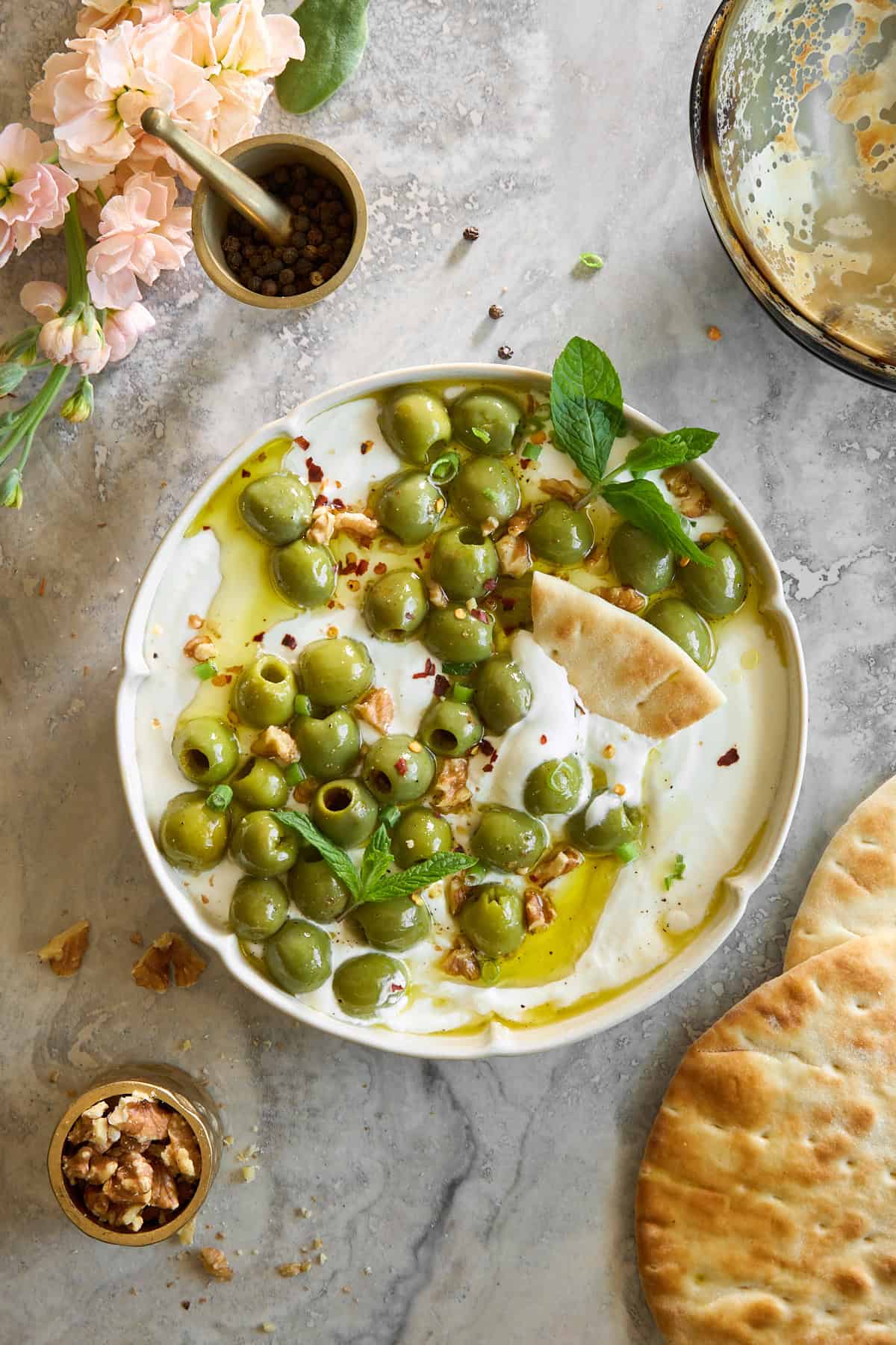 A bowl of whipped cottage cheese marinated olive dip.