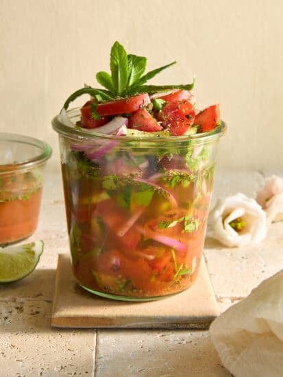 A Whiskey cucumber and tomato salad in a jar.