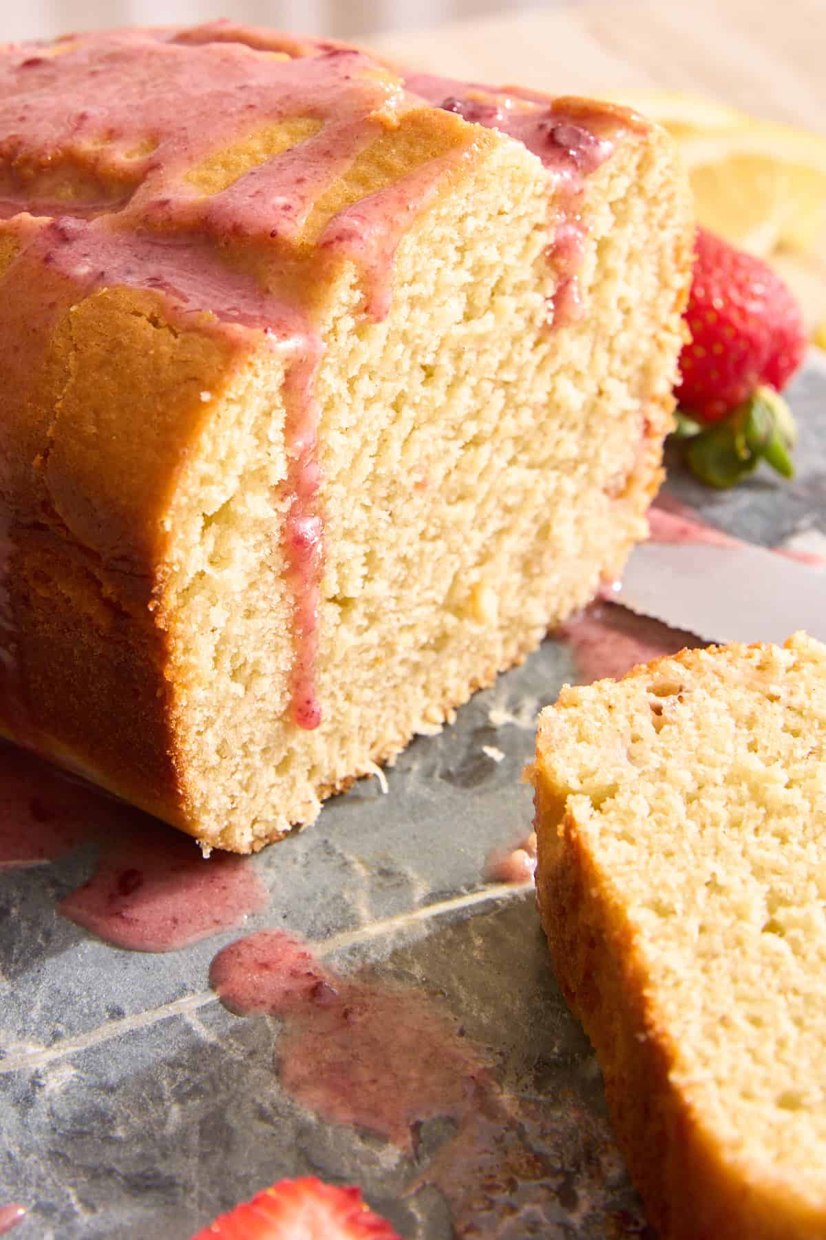 A sliced strawberry lemon olive oil cake